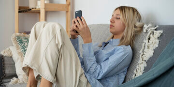 girl on the couch using a smartphone