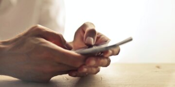 man's hand holding a smartphone