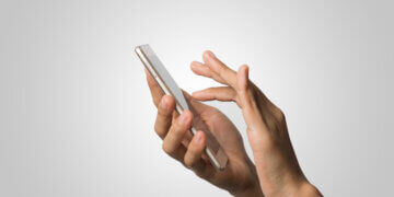 woman hand holding smartphone on a blank screen